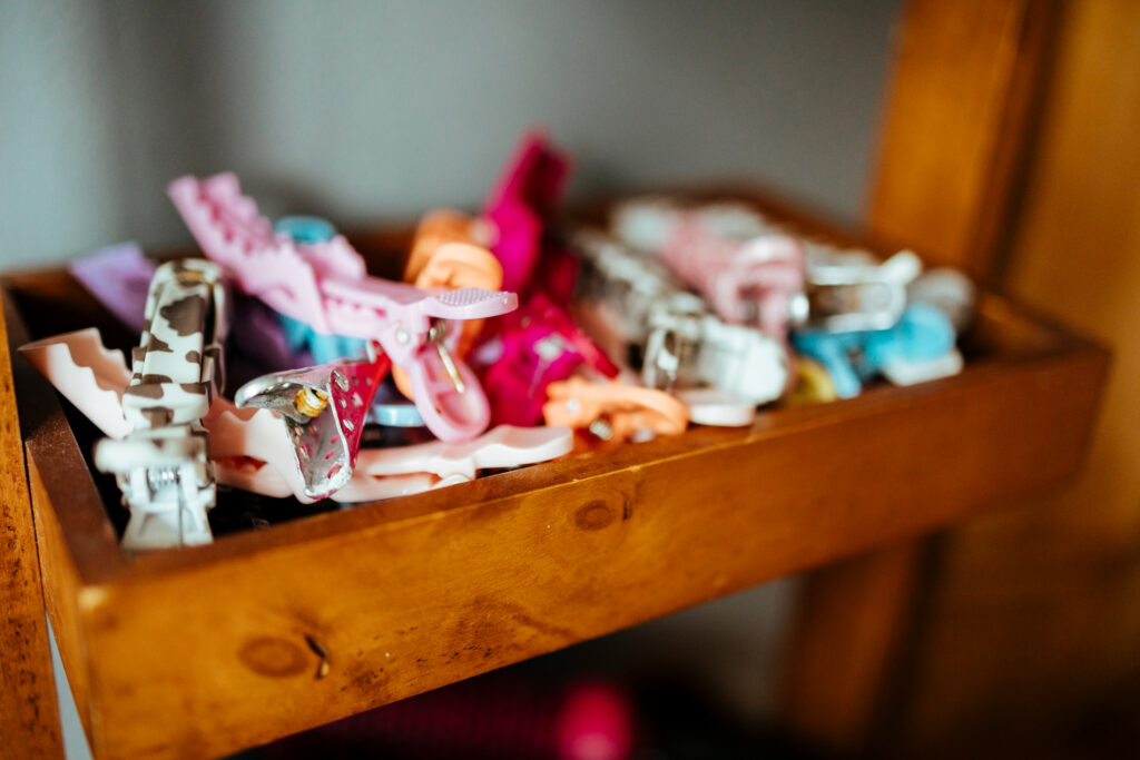 A wooden tray of colourful curl-sectioning clips